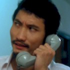 Tsui Hark answers the phone in Yes Madam! (1985)